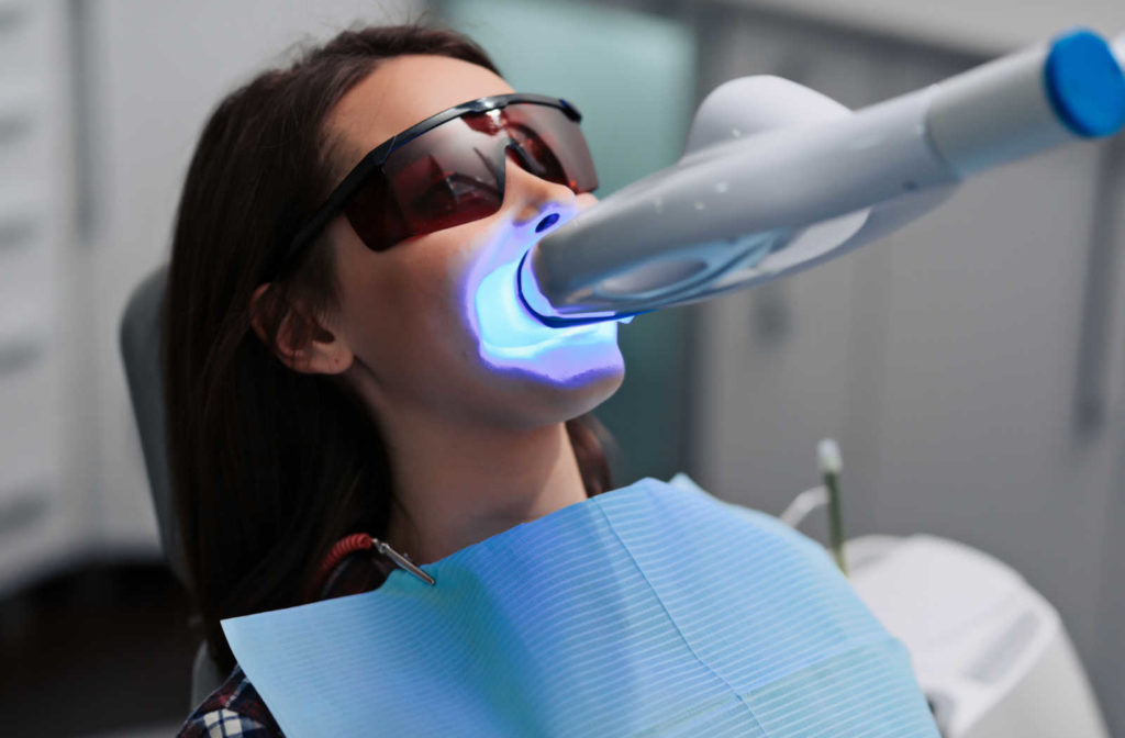 A patient at the dentist office getting a teeth whitening treatment to achieve a brighter and whiter smile