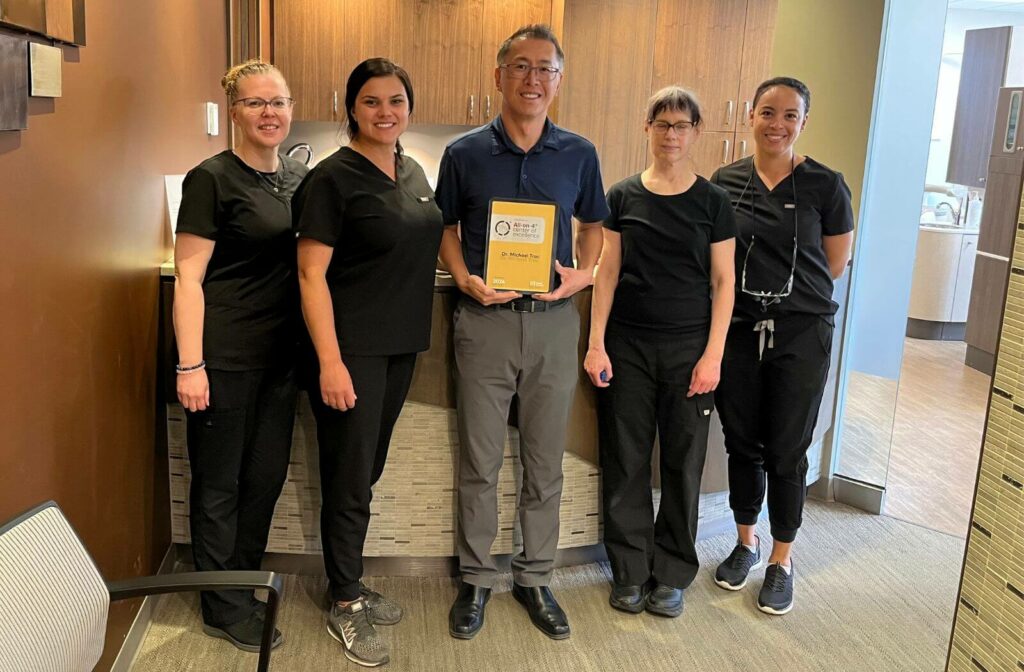 Dr. Trac and the team receiving the All-on-4 Center of Excellence certificate
